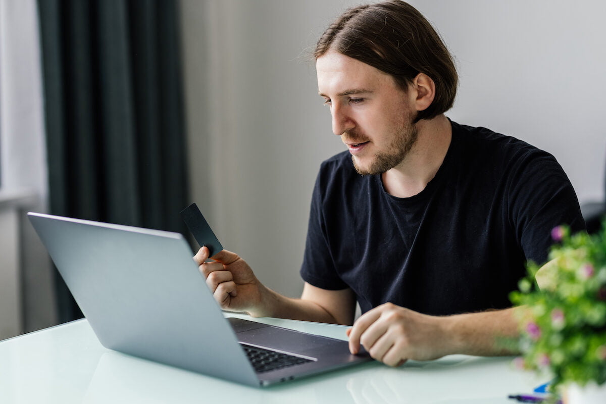 Modern Technology, Business, Career, E Commerce And Online Trading Concept. Businessman Holding Credit Card In One Had And Keyboarding On Laptop With Other Hand, Making Transaction