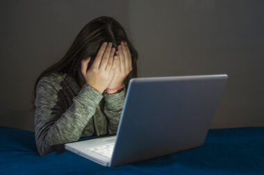 Sad,and,scared,female,teenager,with,computer,laptop,suffering,cyberbullying