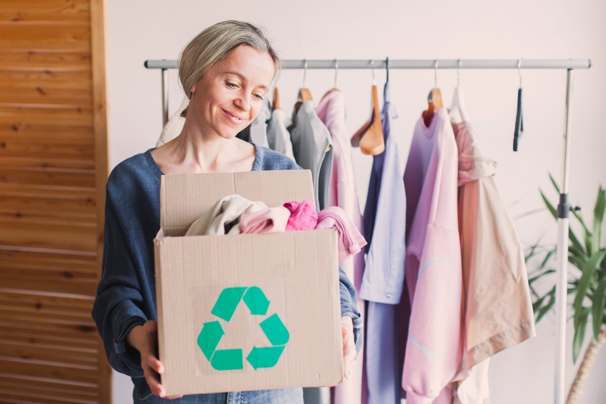 Woman,selecting,clothes,from,her,wardrobe,for,recycle,shop.,woman