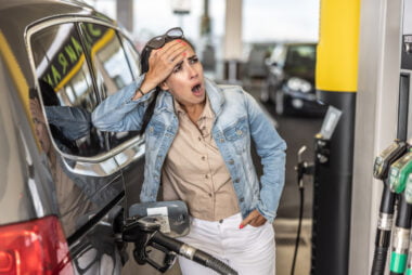 Woman,refuelling,the,tank,of,her,car,with,diesel,looks
