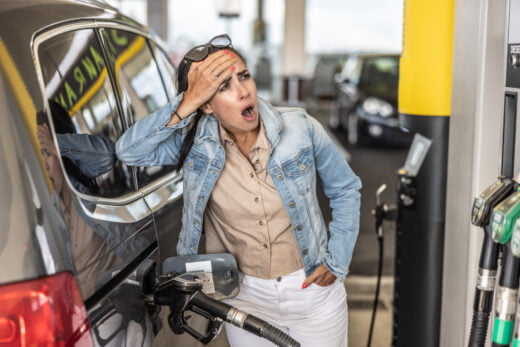 Woman,refuelling,the,tank,of,her,car,with,diesel,looks