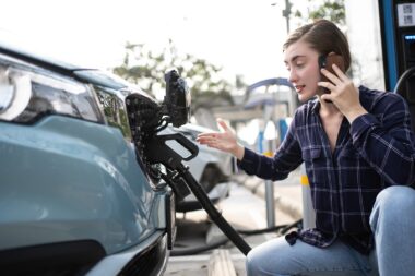 Woman,call,mobile,phone,about,accident,and,breakdowns,with,ev