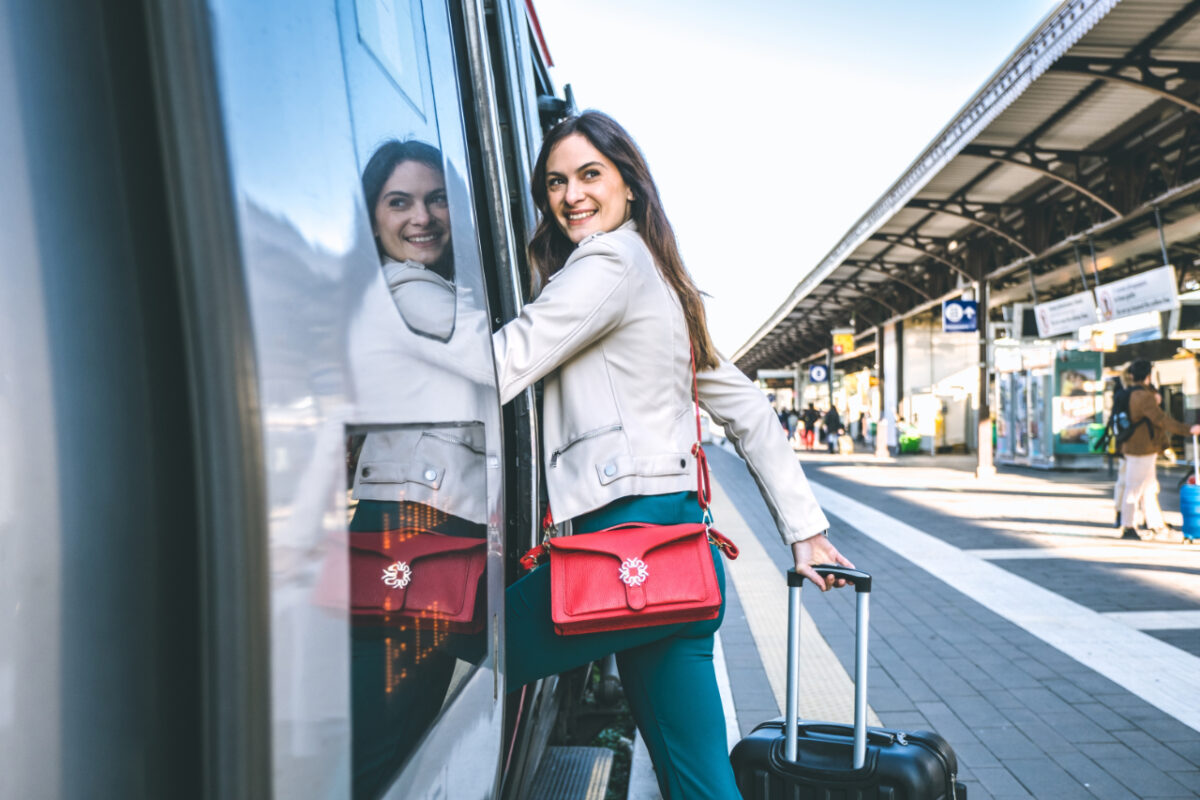 Young,business,woman,standing,on,train,door,peeking,out,looking