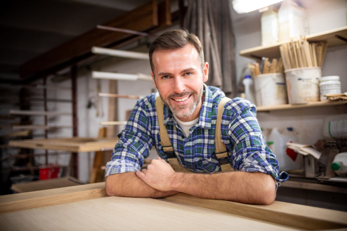 Smiling,and,proud,mature,carpenter,in,his,carpentry,workshop