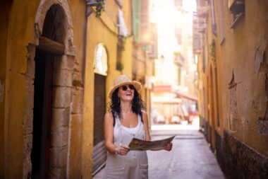 A,tourist,woman,walking,at,the,narrow,streets,of,nice