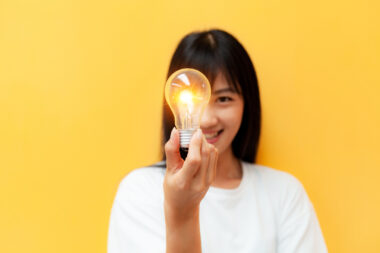 Close Up,of,a,woman,holding,a,glowing,light,bulb,creative