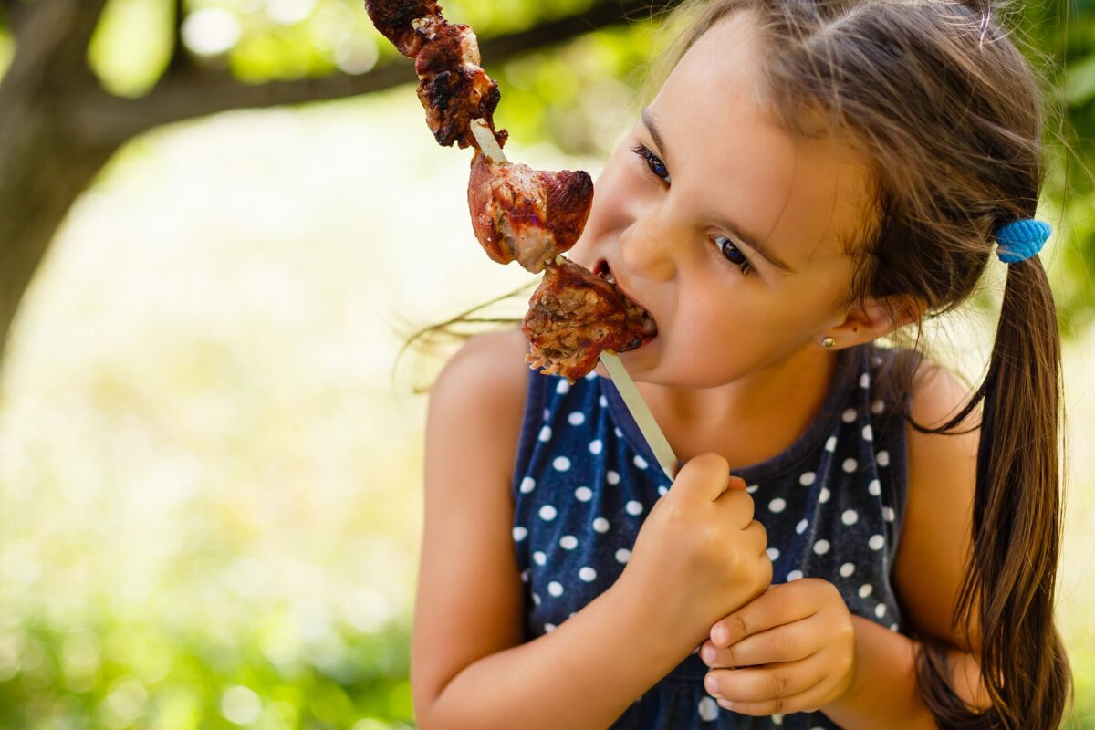 Little,girl,with,pleasure,eats,shish,kebab