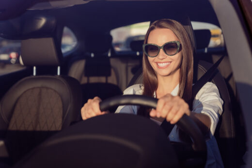 Photo,portrait,smiling,woman,wearing,sunglass,keeping,steering,wheel,in