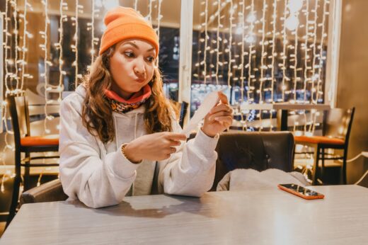 Startled,woman,scrutinizes,the,bill,at,the,cafe,,registering,the