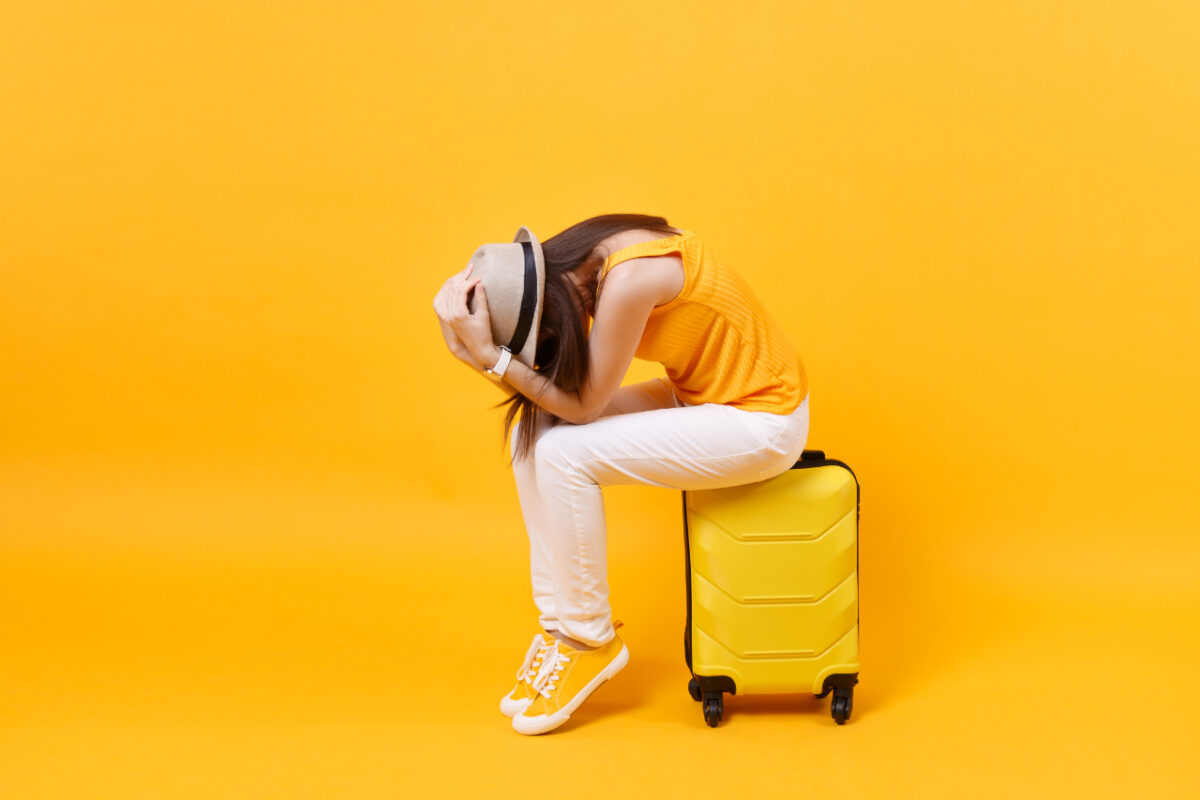 Upset,tourist,woman,in,summer,casual,clothes,sit,on,suitcase