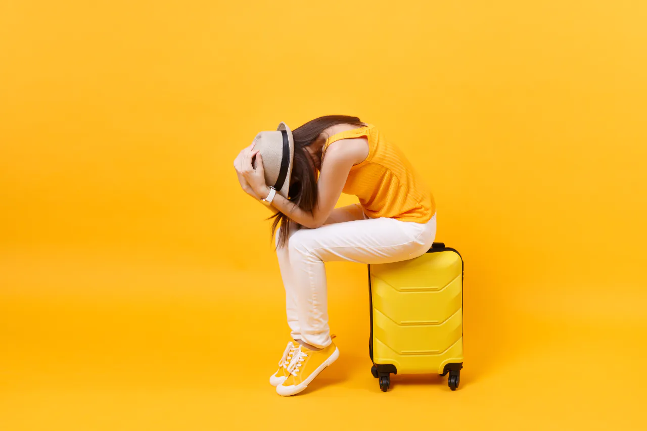 Upset,tourist,woman,in,summer,casual,clothes,sit,on,suitcase