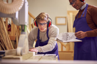 Tutor,with,male,carpentry,student,in,workshop,studying,for,apprenticeship
