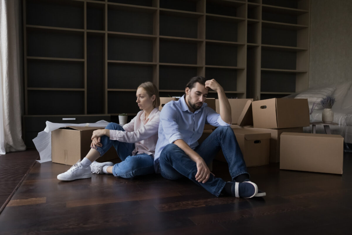 Exhausted,couple,sit,rest,on,floor,in,living,room,near