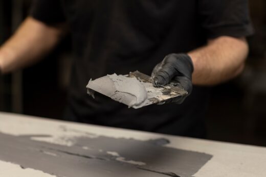 Beton,cire,applied,by,a,mans,hand,wearing,rubber,gloves