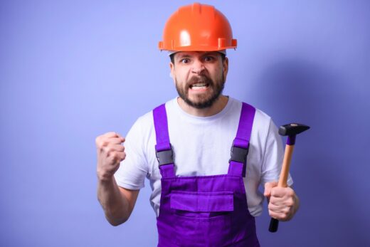 A,young,male,construction,worker,in,a,blue,uniform,and