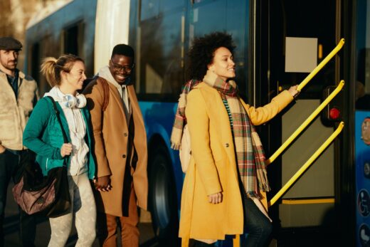 Small,group,of,happy,commuters,getting,in,a,bus,at