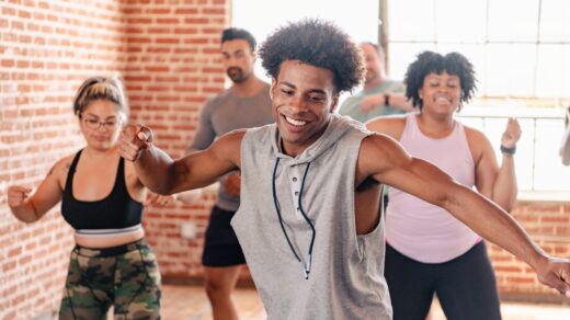 Group,dance,class,with,diverse,participants,enjoying,exercise.,smiling,individuals