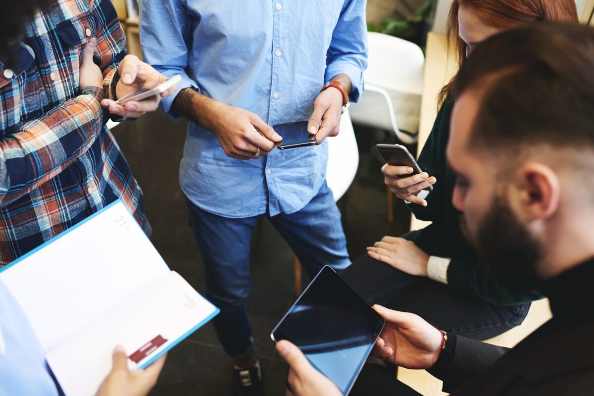 Team,of,male,and,female,it,developers,using,digital,gadgets