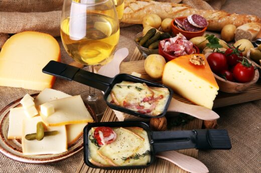 Delicious,traditional,swiss,melted,raclette,cheese,on,diced,boiled,or