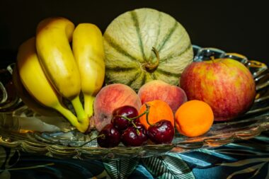 Glass,fruit,bowl,with,honeydew,melon,,apple,,bananas,,peaches,,apricots