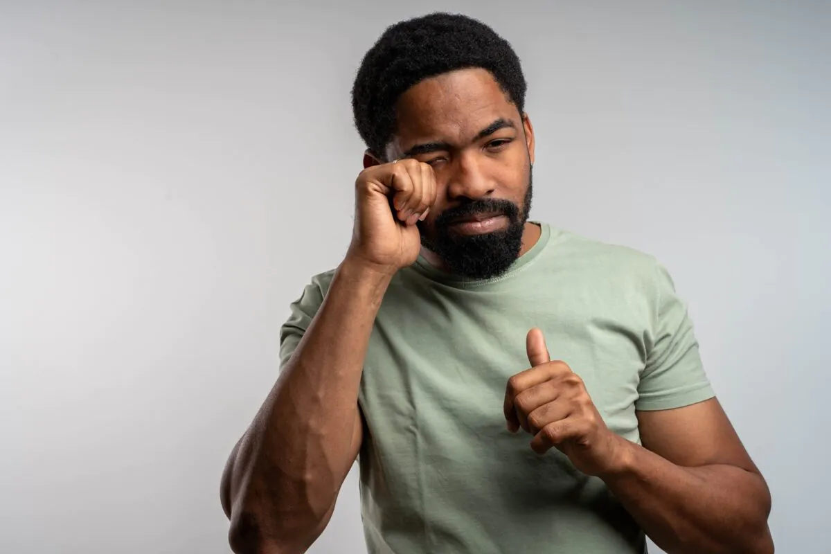 Black,man,rubbing,eyes,with,discomfort,,irritated,and,tired,,experiencing