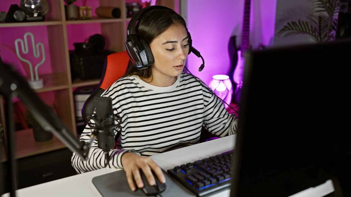 Hispanic,woman,streams,videogames,in,a,neon Lit,home,office,,showcasing